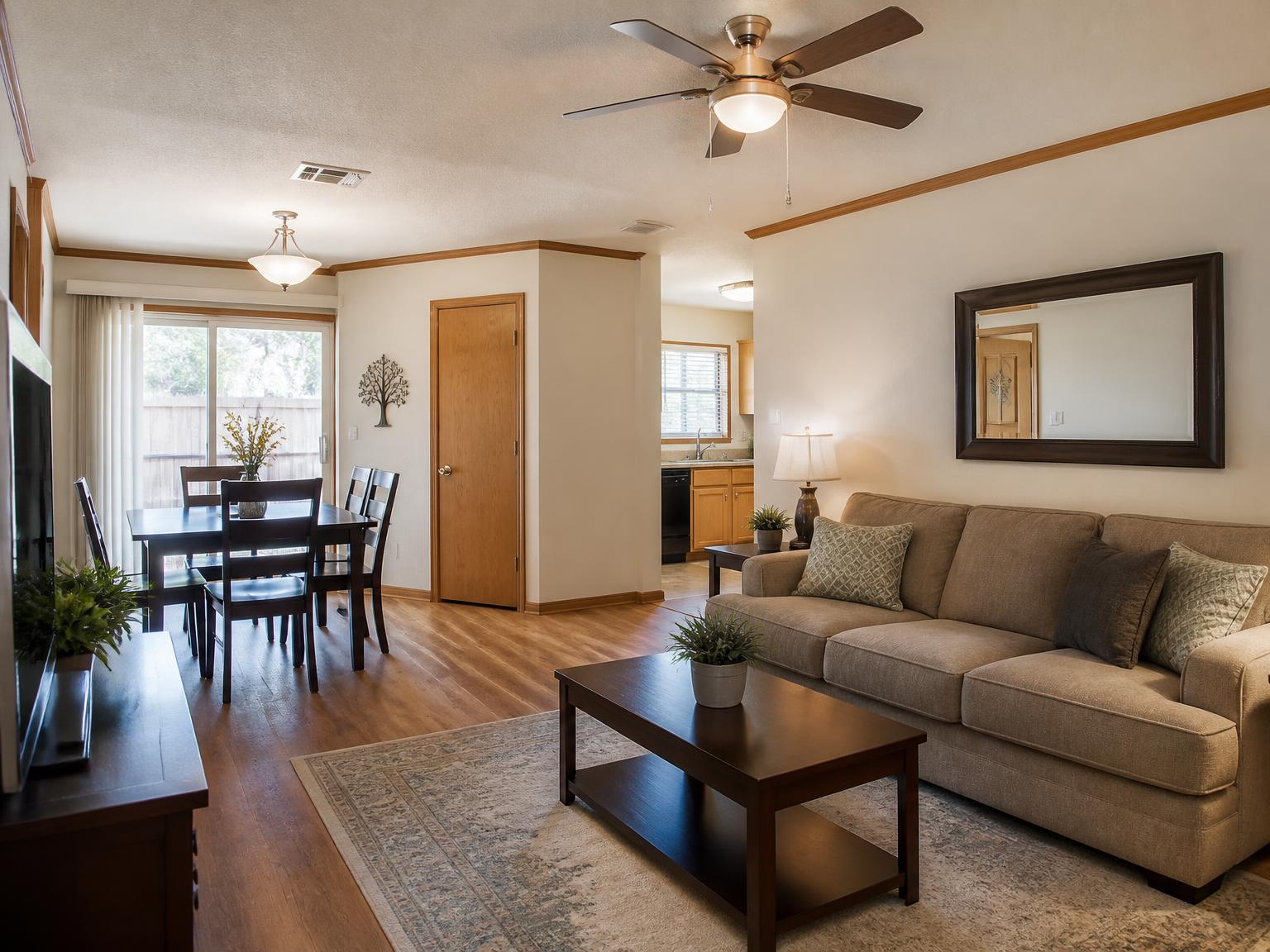 Representative spacious townhome living and dining area with warm wood finishes